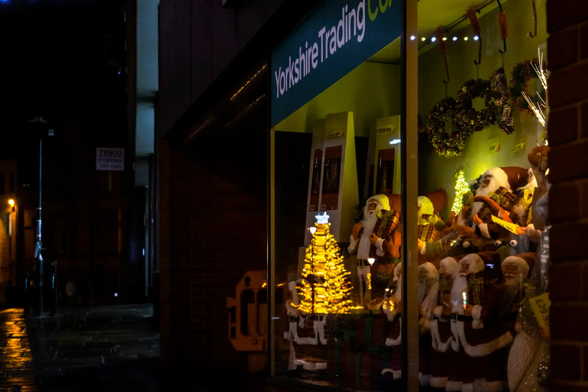Shopfront lit up with Christmas decorations in the evening